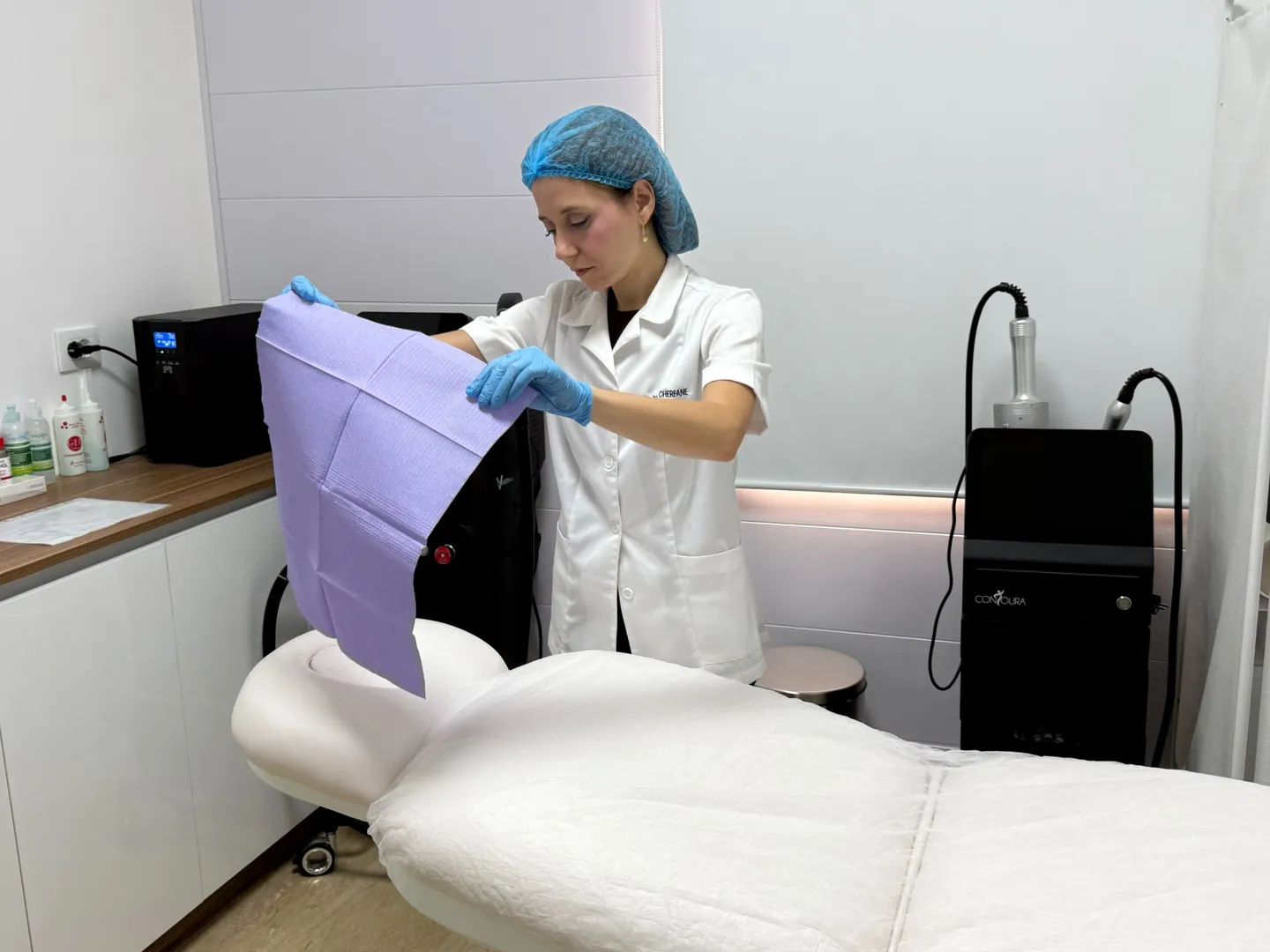 Rita preparing the treatment bed beside the Contoura equipment