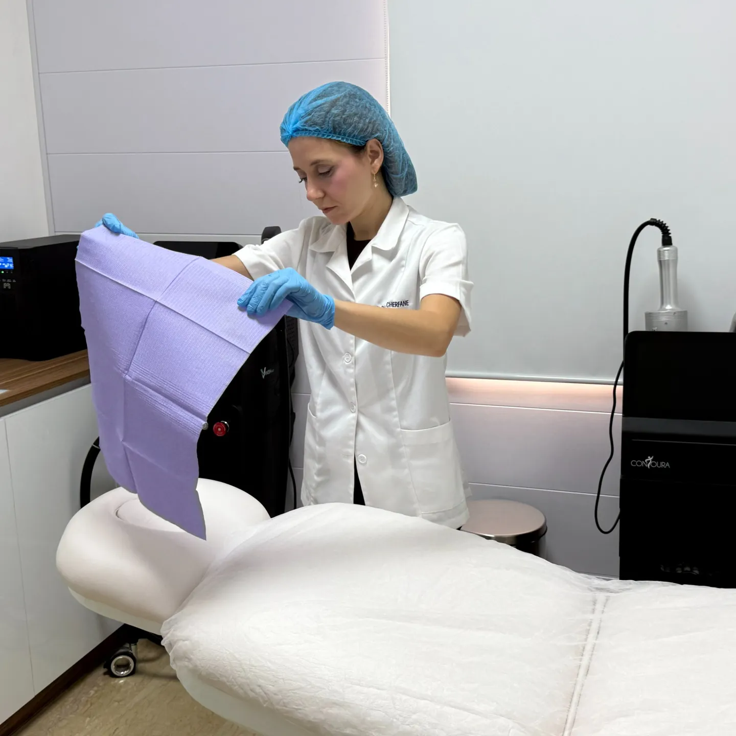 Rita preparing a treatment room with Contoura equipment visible