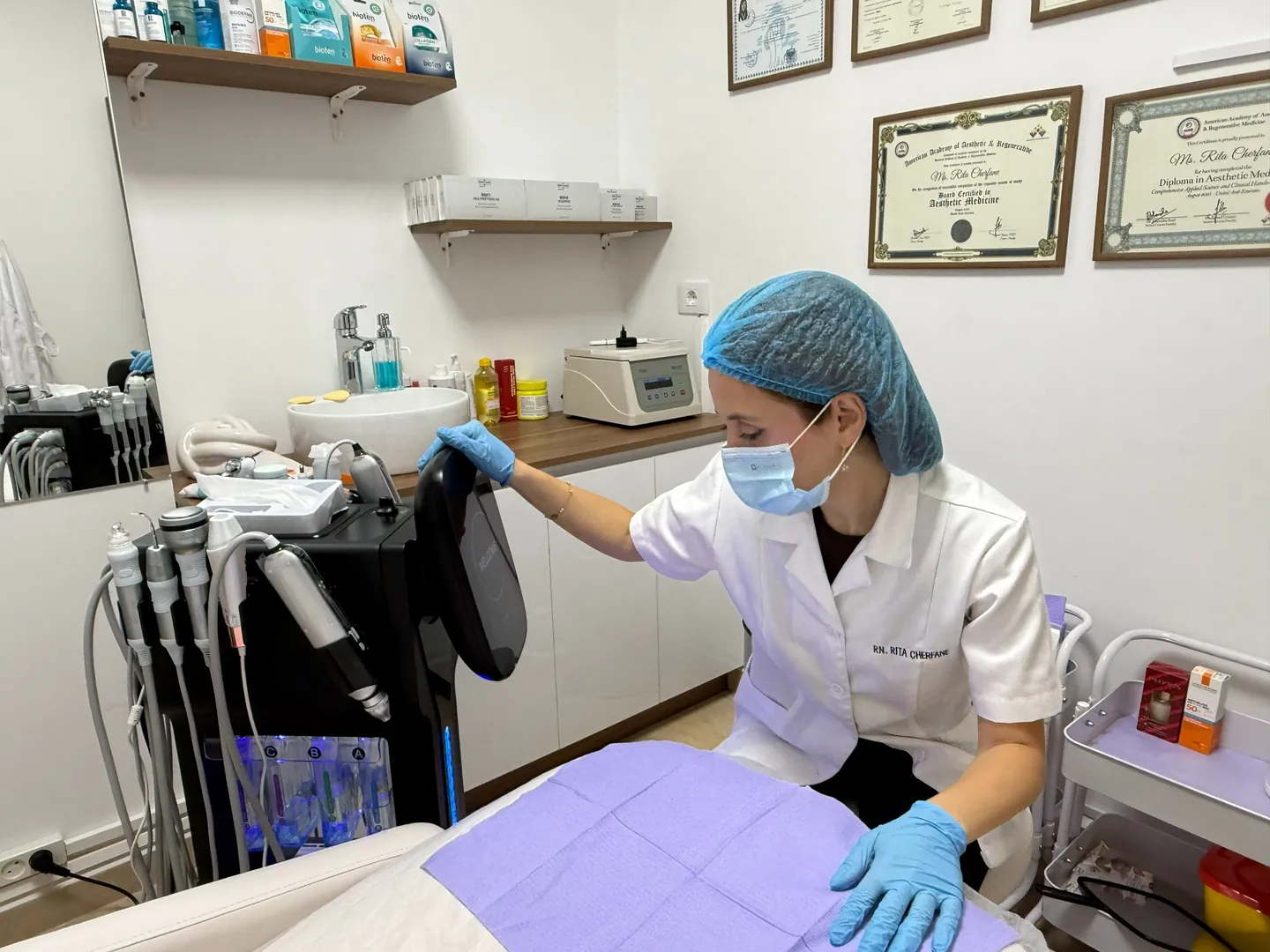 Rita checking the HydraFacial device before an appointment