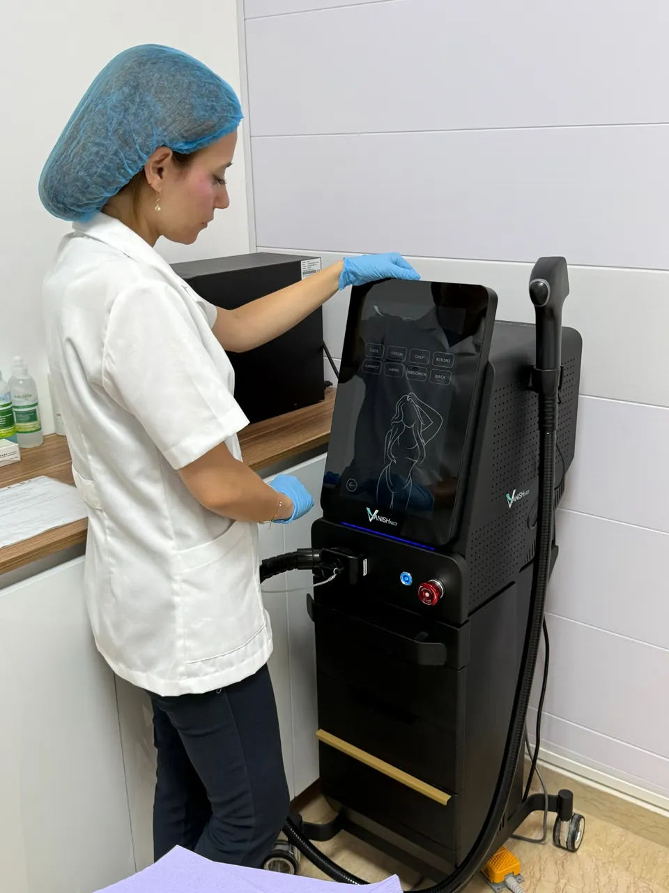 Rita preparing laser equipment at her clinic in Baabda