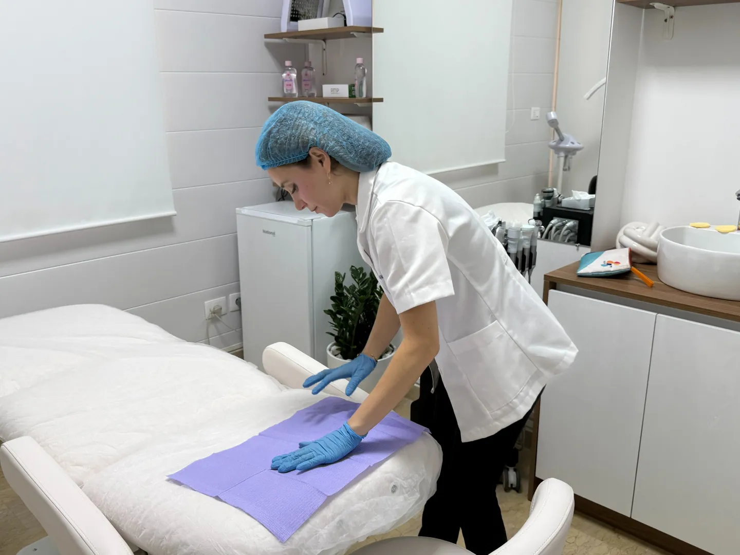 Rita preparing a treatment room before a skin appointment
